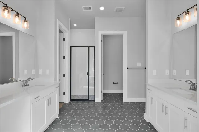 a spacious bathroom with a double vanity sink mirror and double