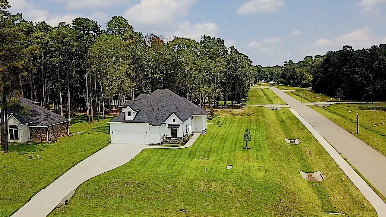 28502 Tallow Rock Lane Huffman, TX 77336 - Photo 2 of 30 a view of a swimming pool with a patio