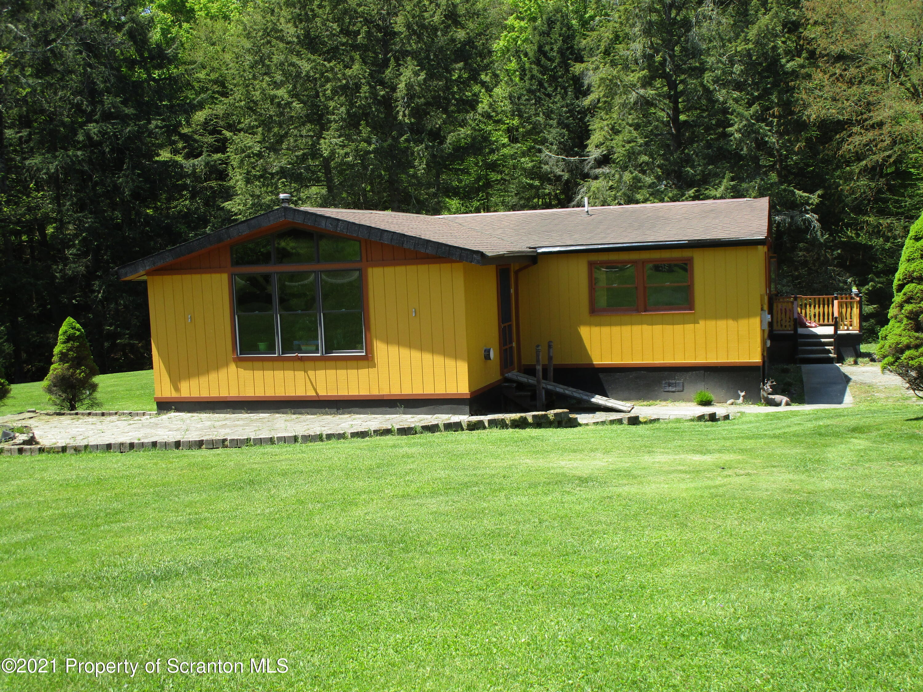 1709 Mill Creek Road Le Raysville, PA 18829 - Photo 1 of 41 a front view of house with yard and trees