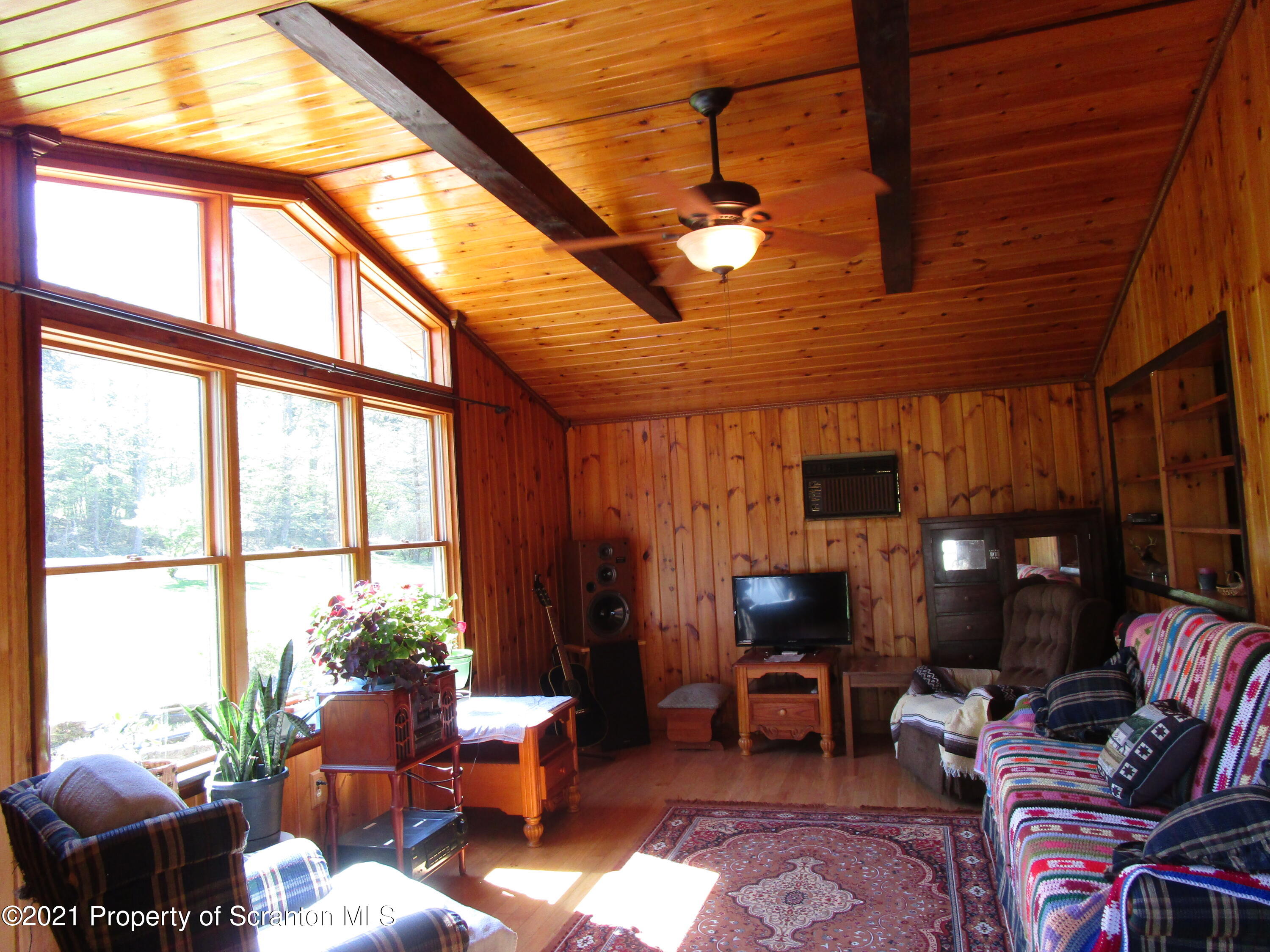 1709 Mill Creek Road Le Raysville, PA 18829 - Photo 11 of 41 a living room with furniture and a large window