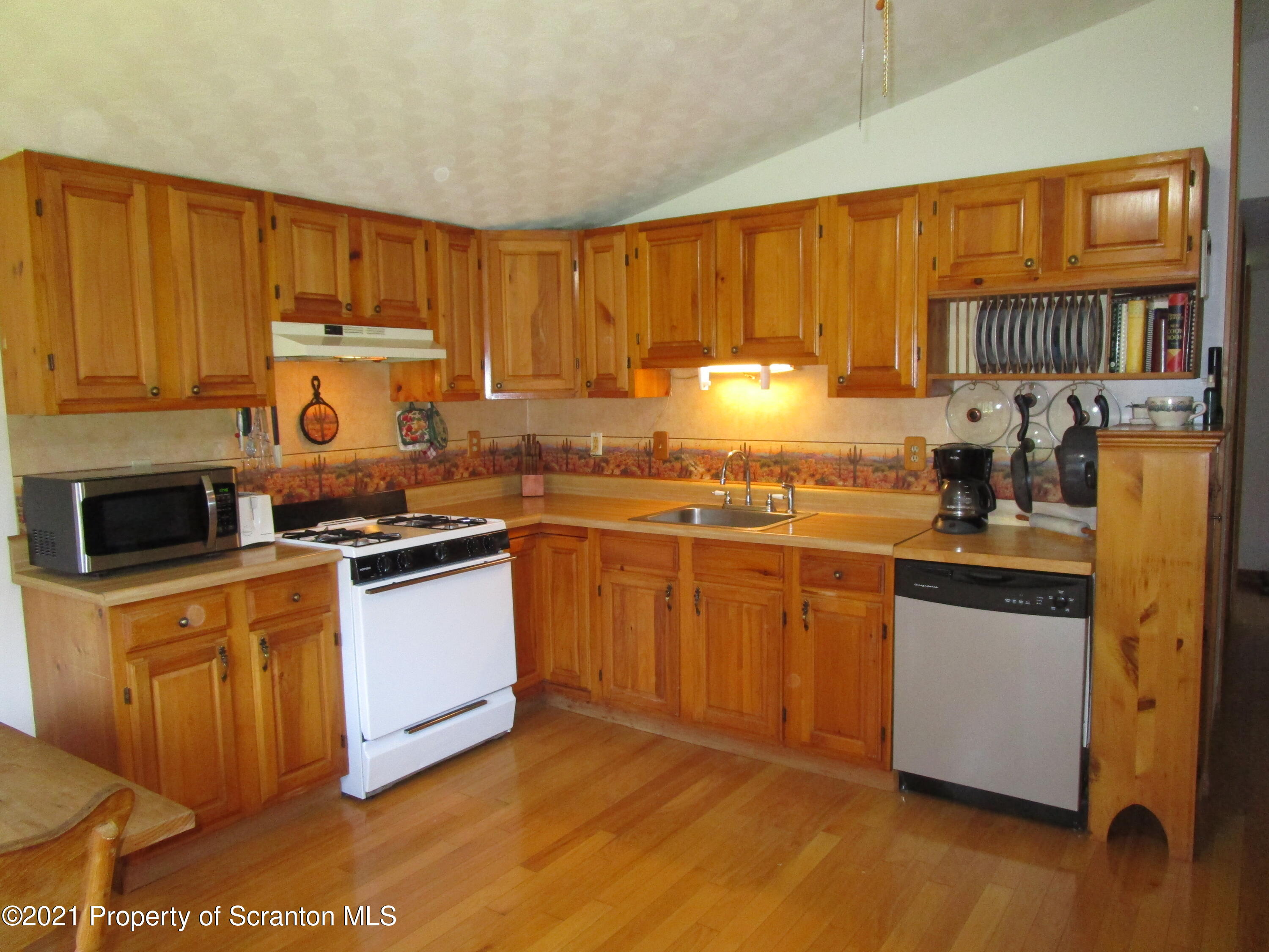 1709 Mill Creek Road Le Raysville, PA 18829 - Photo 15 of 41 a kitchen with stainless steel appliances granite countertop a stove a sink dishwasher and a refrigerator