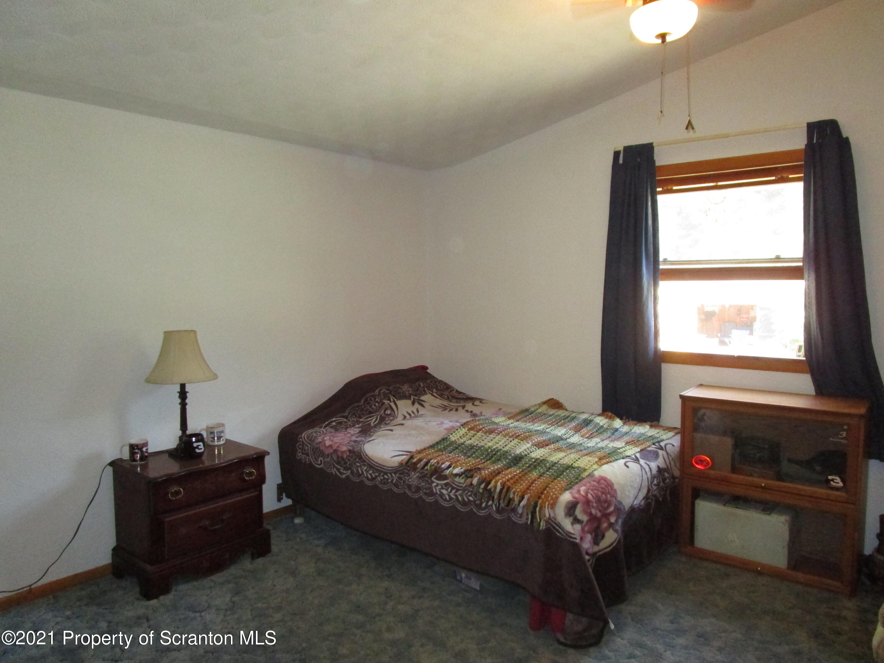 1709 Mill Creek Road Le Raysville, PA 18829 - Photo 20 of 41 a bed sitting in a bedroom next to a window