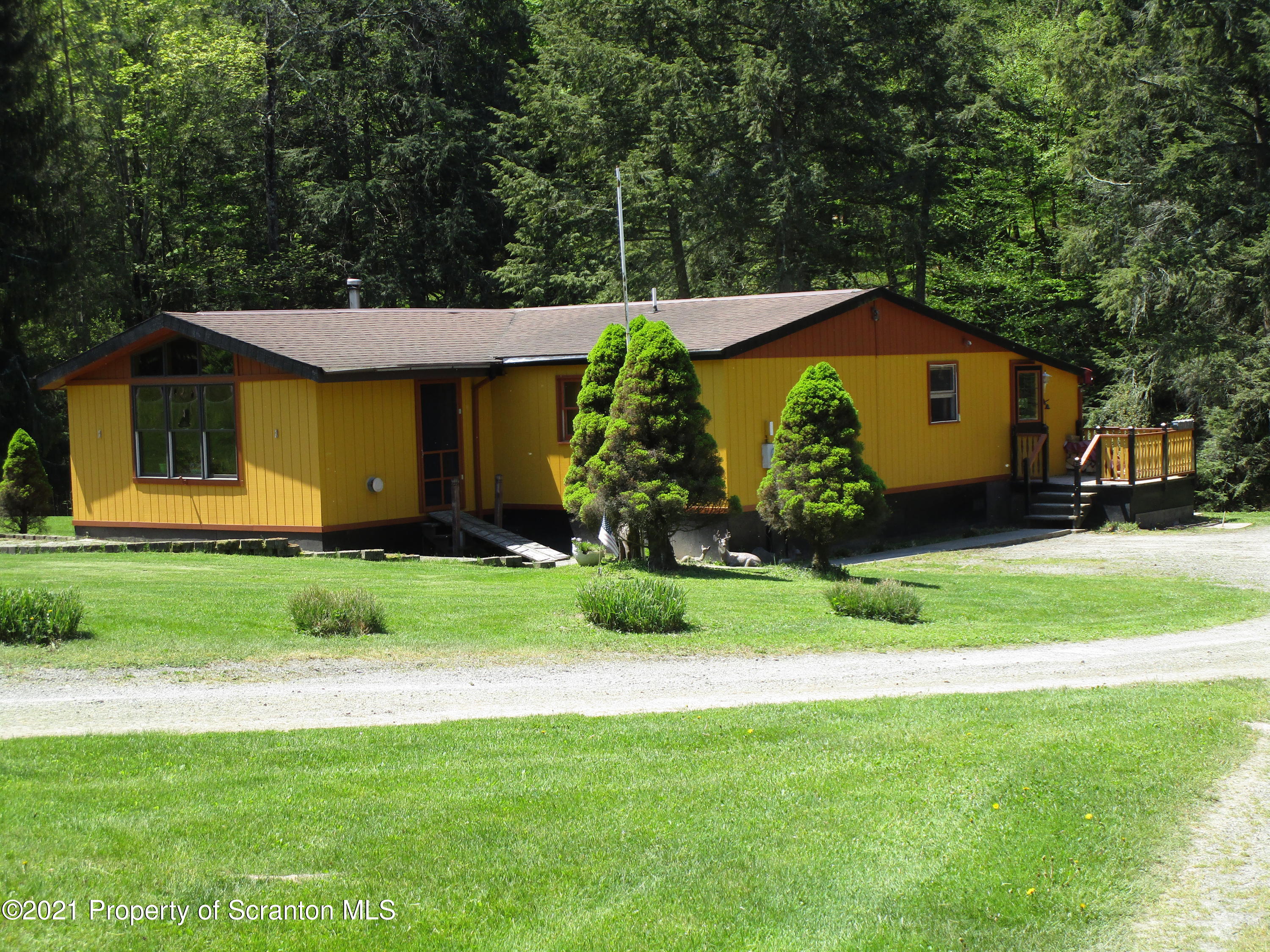 1709 Mill Creek Road Le Raysville, PA 18829 - Photo 2 of 41 a front view of a house with garden