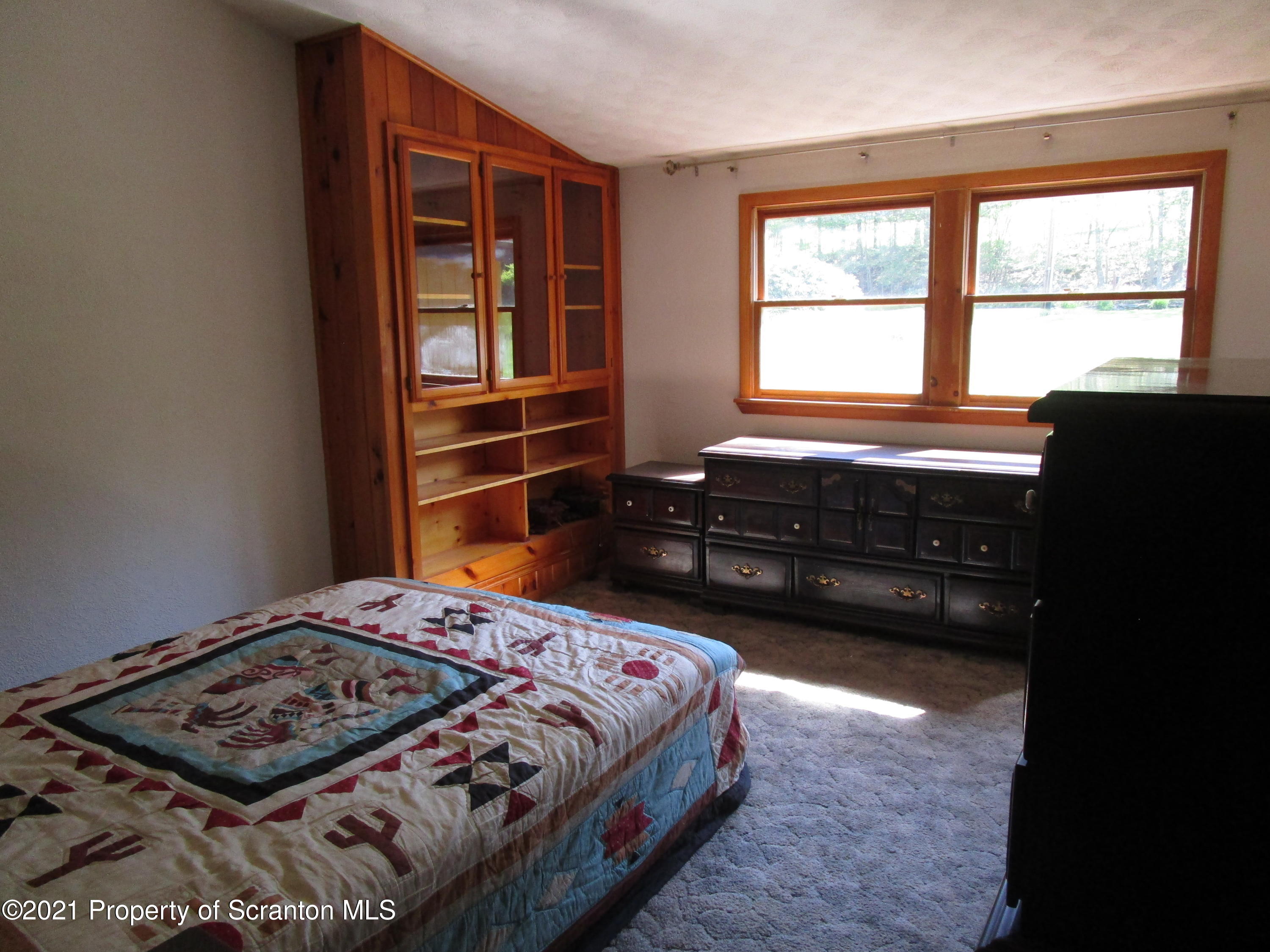 1709 Mill Creek Road Le Raysville, PA 18829 - Photo 24 of 41 a bedroom with a bed and a window