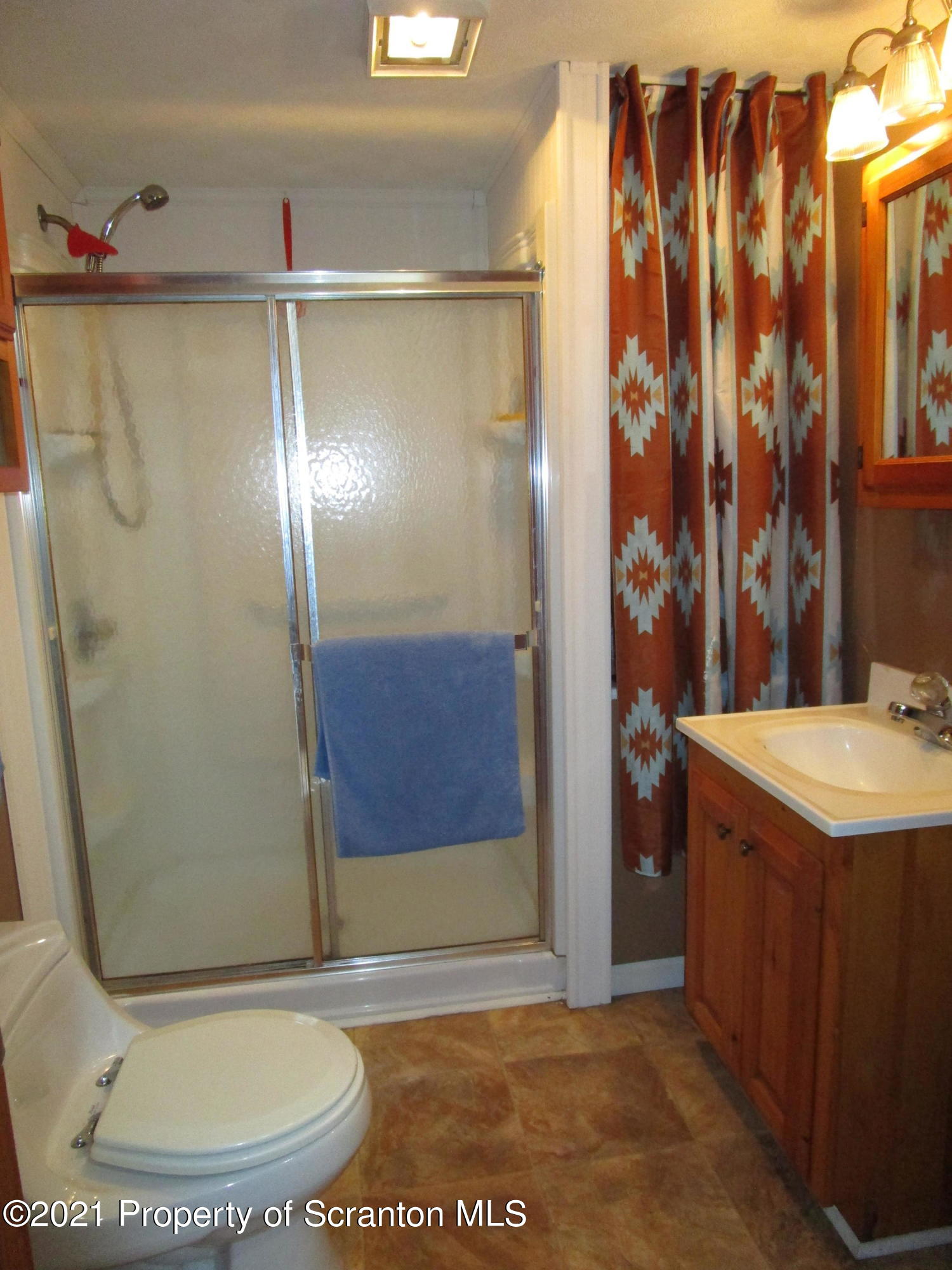 1709 Mill Creek Road Le Raysville, PA 18829 - Photo 25 of 41 a bathroom with a granite countertop shower a mirror and a sink