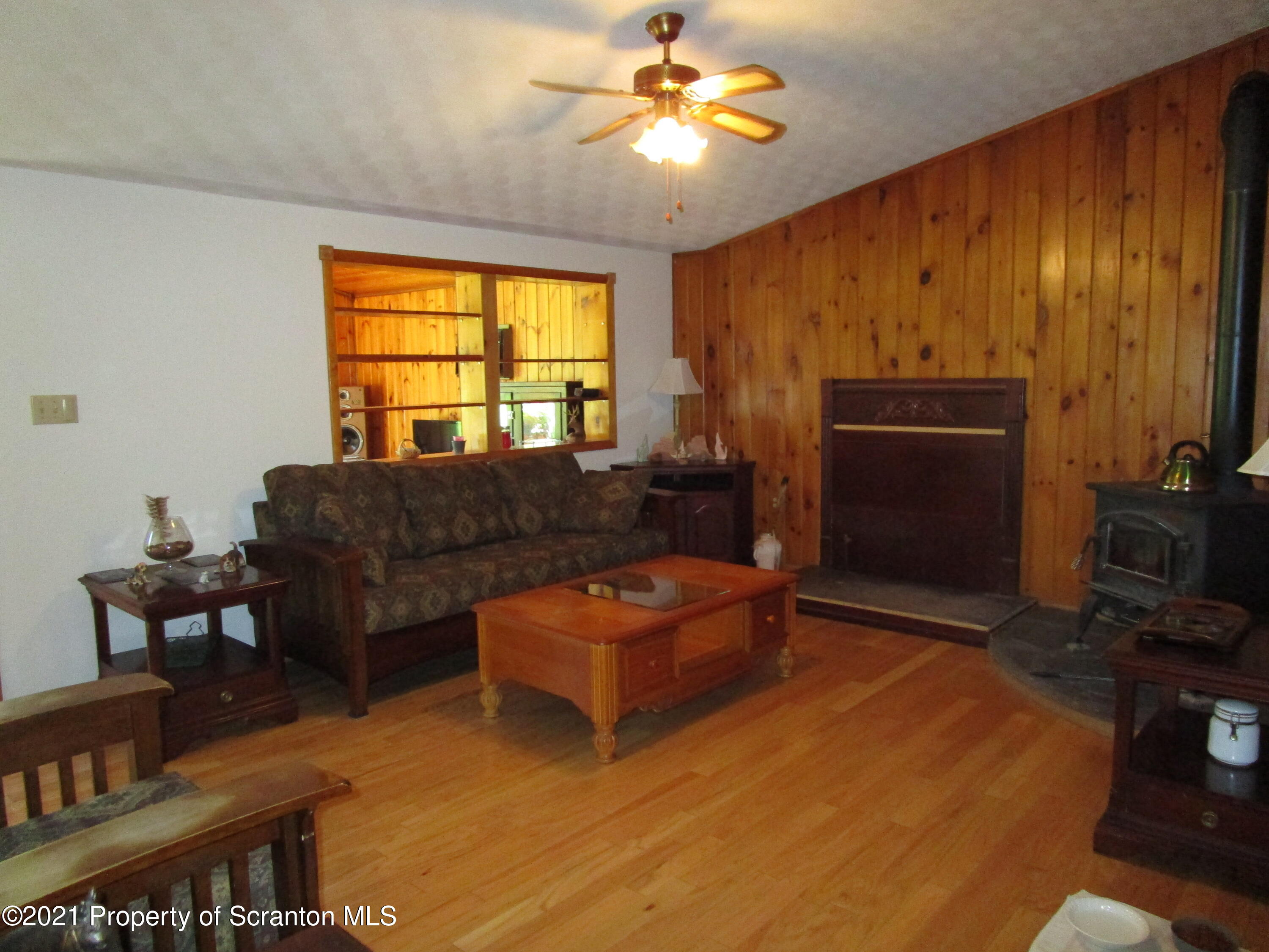 1709 Mill Creek Road Le Raysville, PA 18829 - Photo 7 of 41 a living room with furniture a flat screen tv and a window