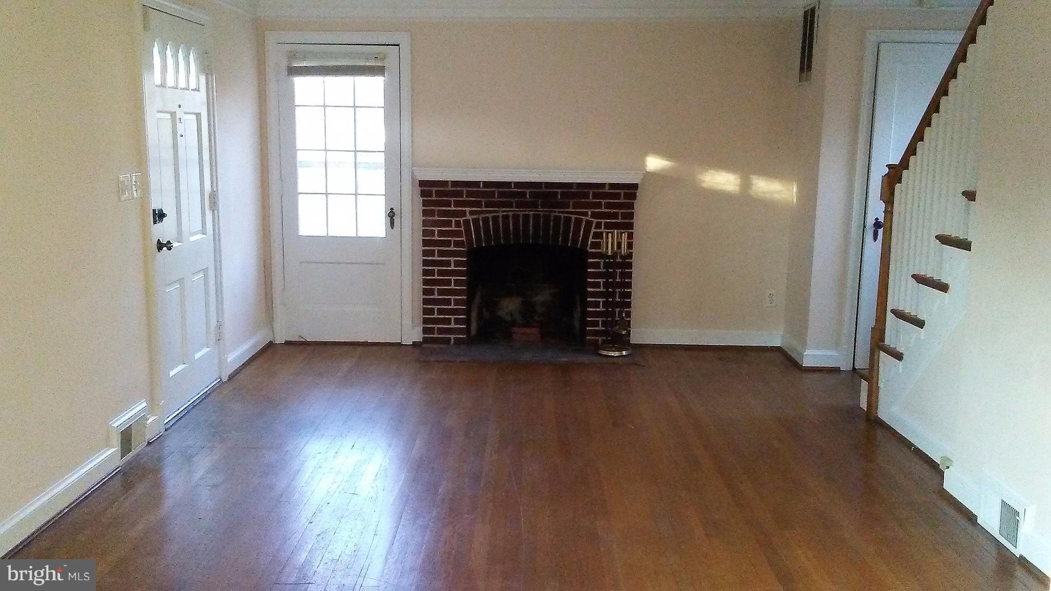9908 Cherry Tree Lane Silver Spring, MD 20901 - Photo 3 of 15 Living room w/ fireplace and ceiling fan