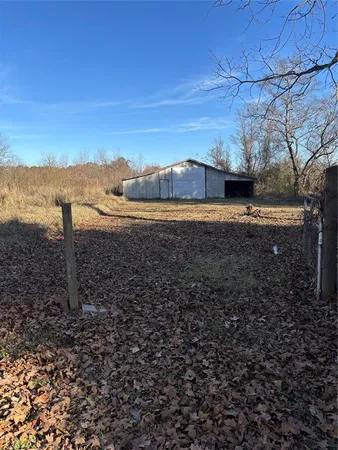 a view of a yard with wooden fence