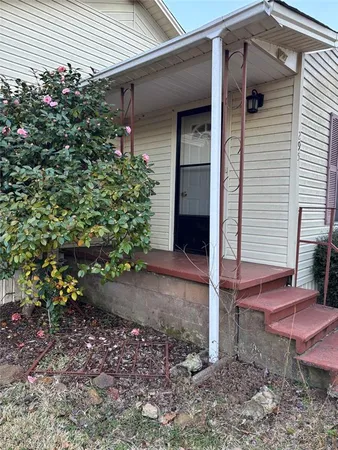 a backyard of a house with plants and outdoor seating