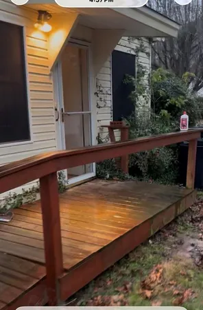 a view of a balcony with wooden floor and potted plants
