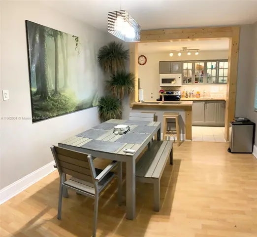 a kitchen with a table and chairs