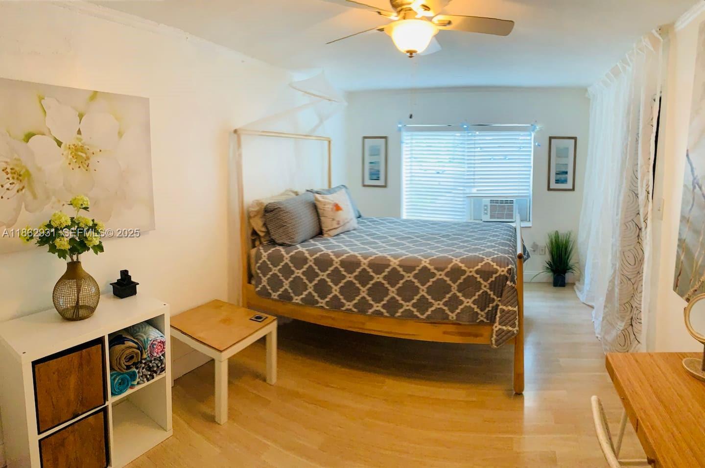 769 Northwest 10th Street Miami, FL 33136 - Photo 18 of 25 a bedroom with a bed and a chandelier