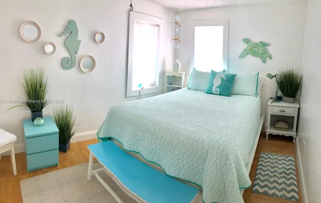 a bedroom with a bed and a potted plant