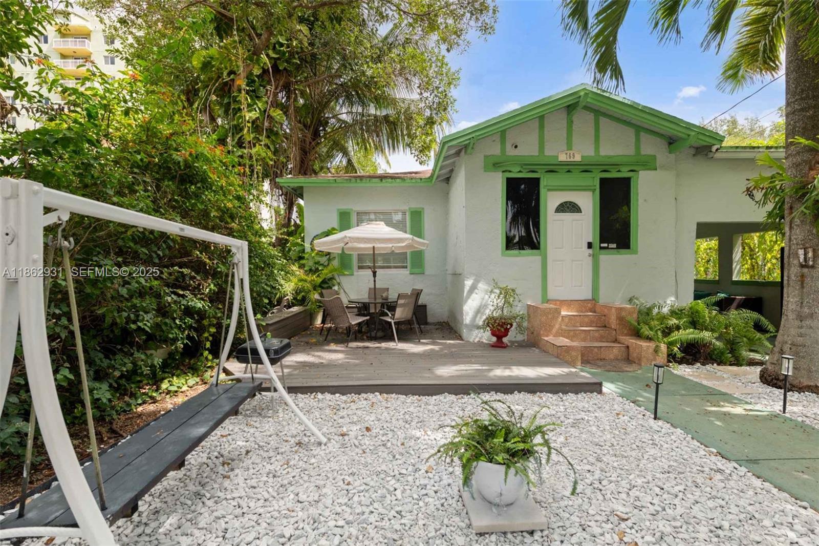 769 Northwest 10th Street Miami, FL 33136 - Photo 2 of 25 a front view of a house with a yard