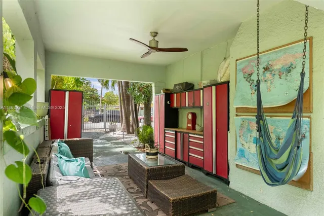 a living room with patio furniture and a potted plant