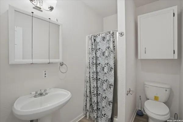 a bathroom with a toilet sink and shower