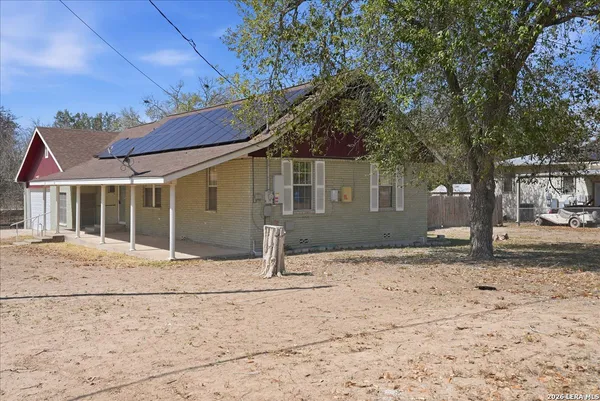 a view of a house with a yard and a street