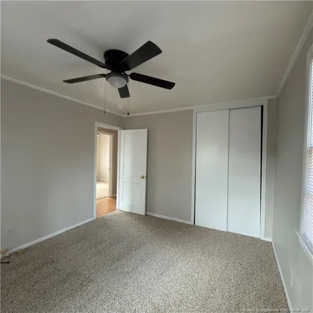 a view of an empty room and a ceiling fan