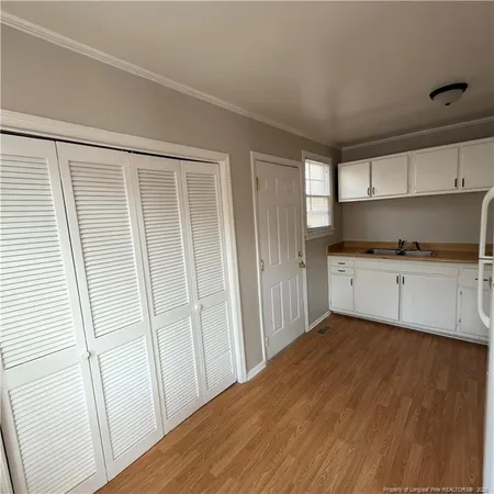 a view of a kitchen with wooden floor