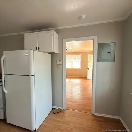 a white refrigerator freezer and a stove sitting inside of a kitchen