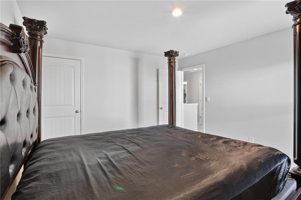 930 Sly Fox Run Fairburn, GA 30213 - Photo 11 of 28 a bedroom with a bed and a closet