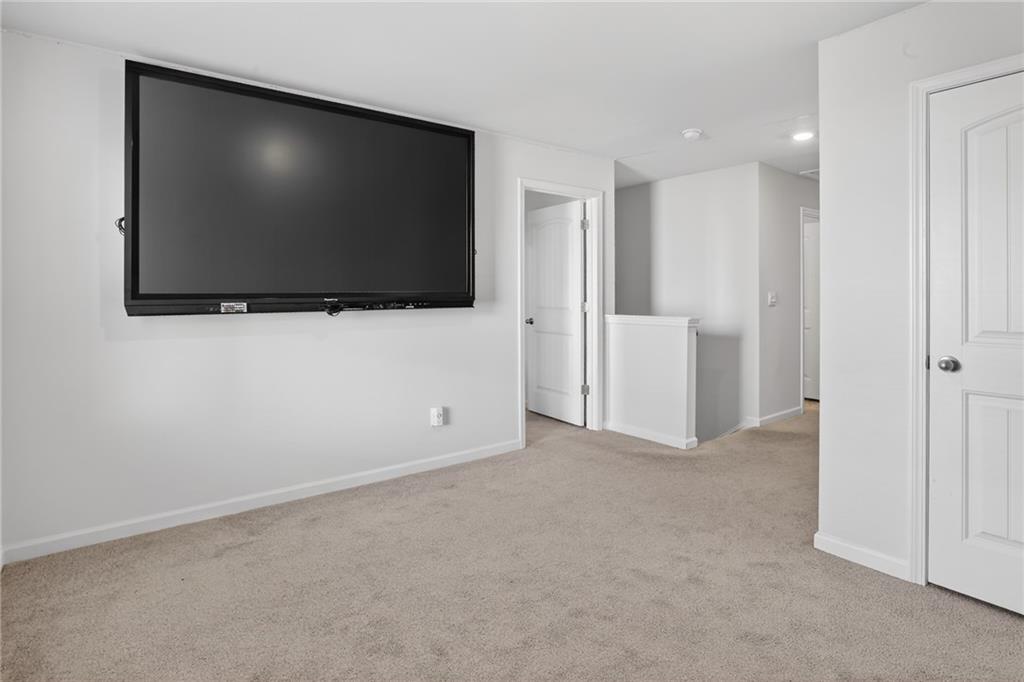 930 Sly Fox Run Fairburn, GA 30213 - Photo 12 of 28 a view of an empty room with a flat screen tv