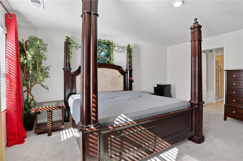 930 Sly Fox Run Fairburn, GA 30213 - Photo 15 of 28 a bedroom with bed and a window