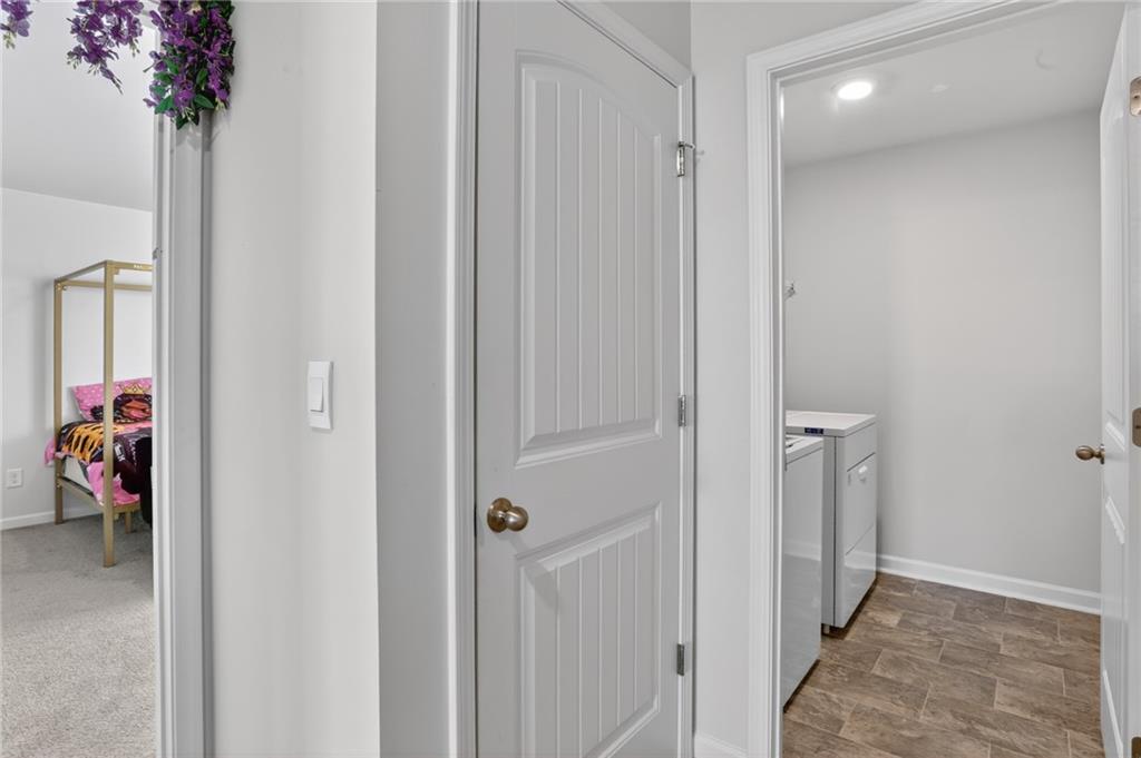 930 Sly Fox Run Fairburn, GA 30213 - Photo 21 of 28 a view of a hallway with closet and a livingroom view