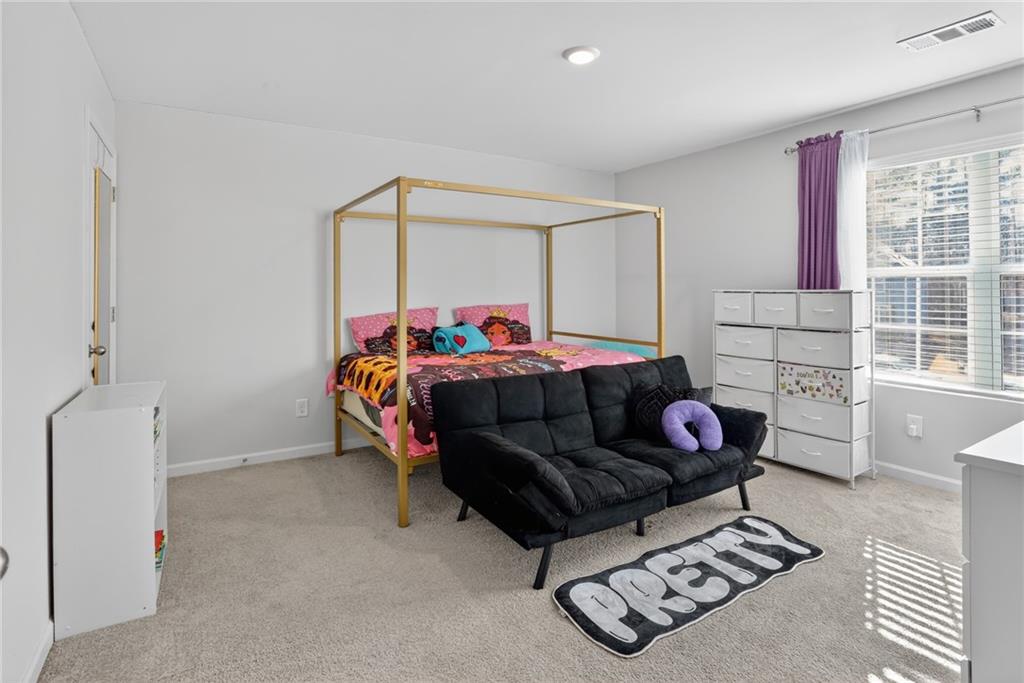 930 Sly Fox Run Fairburn, GA 30213 - Photo 22 of 28 a bedroom with a bed and window