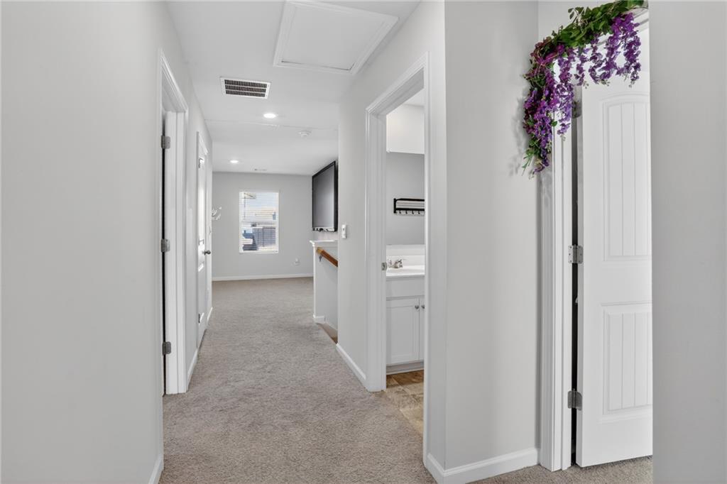930 Sly Fox Run Fairburn, GA 30213 - Photo 23 of 28 a view of a hallway with wooden shelves