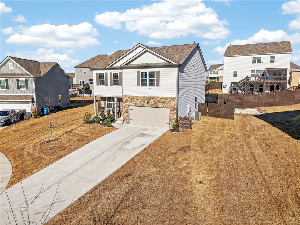 930 Sly Fox Run Fairburn, GA 30213 - Photo 27 of 28 a view of a white house with large windows next to a road