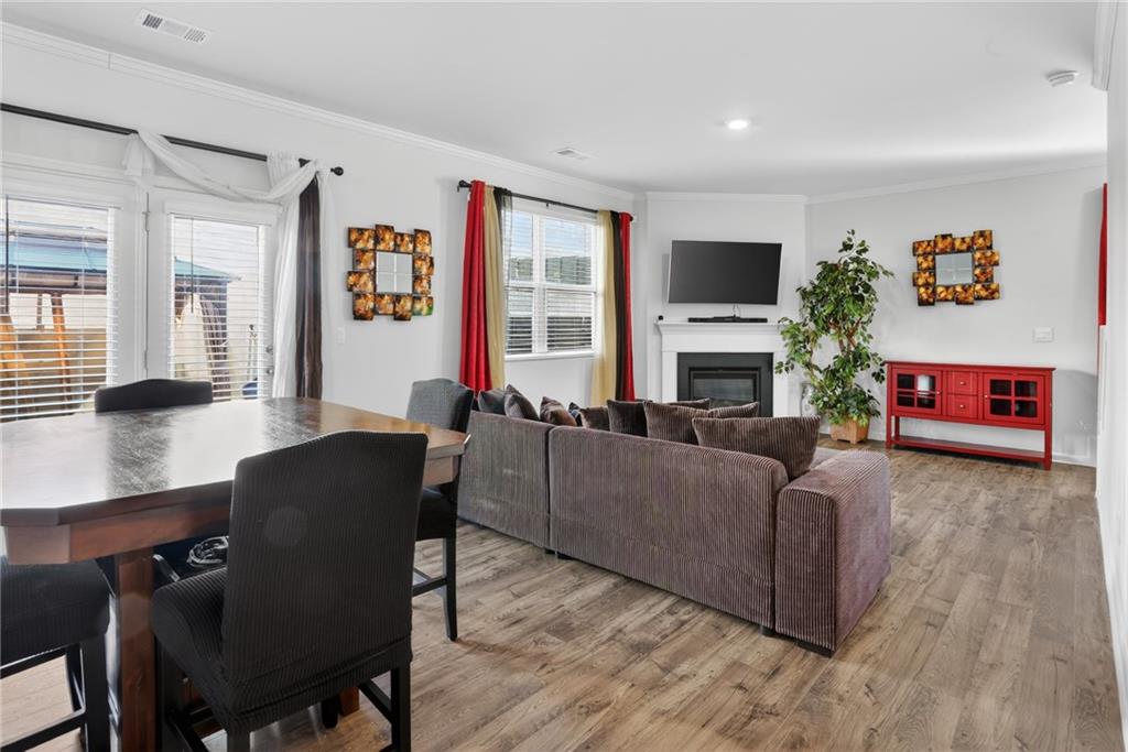 930 Sly Fox Run Fairburn, GA 30213 - Photo 5 of 28 a living room with furniture a flat screen tv and a fireplace