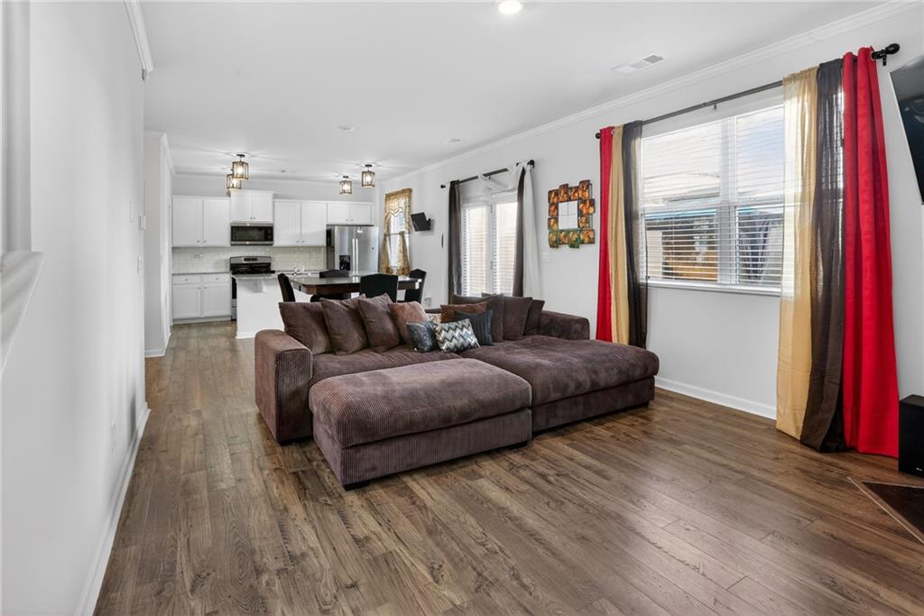 930 Sly Fox Run Fairburn, GA 30213 - Photo 6 of 28 a living room with furniture and a wooden floor