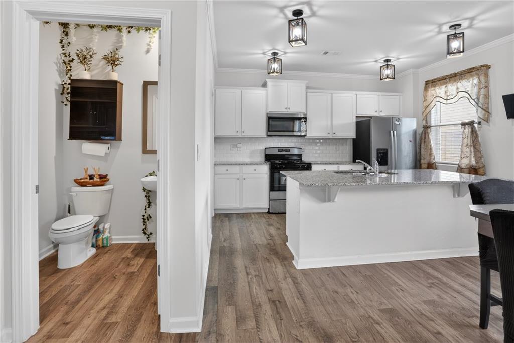 930 Sly Fox Run Fairburn, GA 30213 - Photo 7 of 28 a view of kitchen with stainless steel appliances kitchen island sink stove and refrigerator