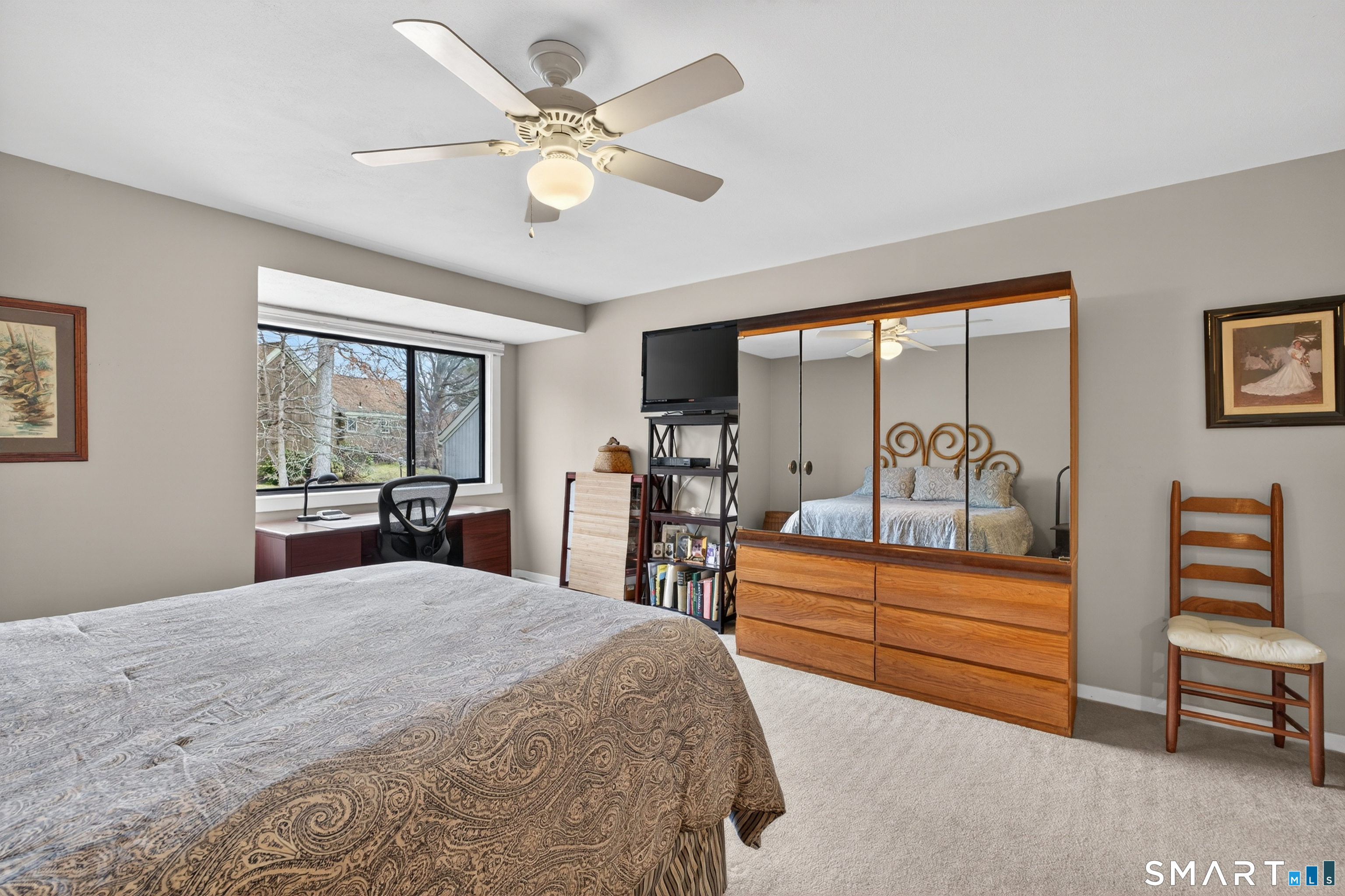 196 Apache Lane, Unit A Stratford, CT 06614 - Photo 21 of 40 a bedroom with a bed and a chandelier