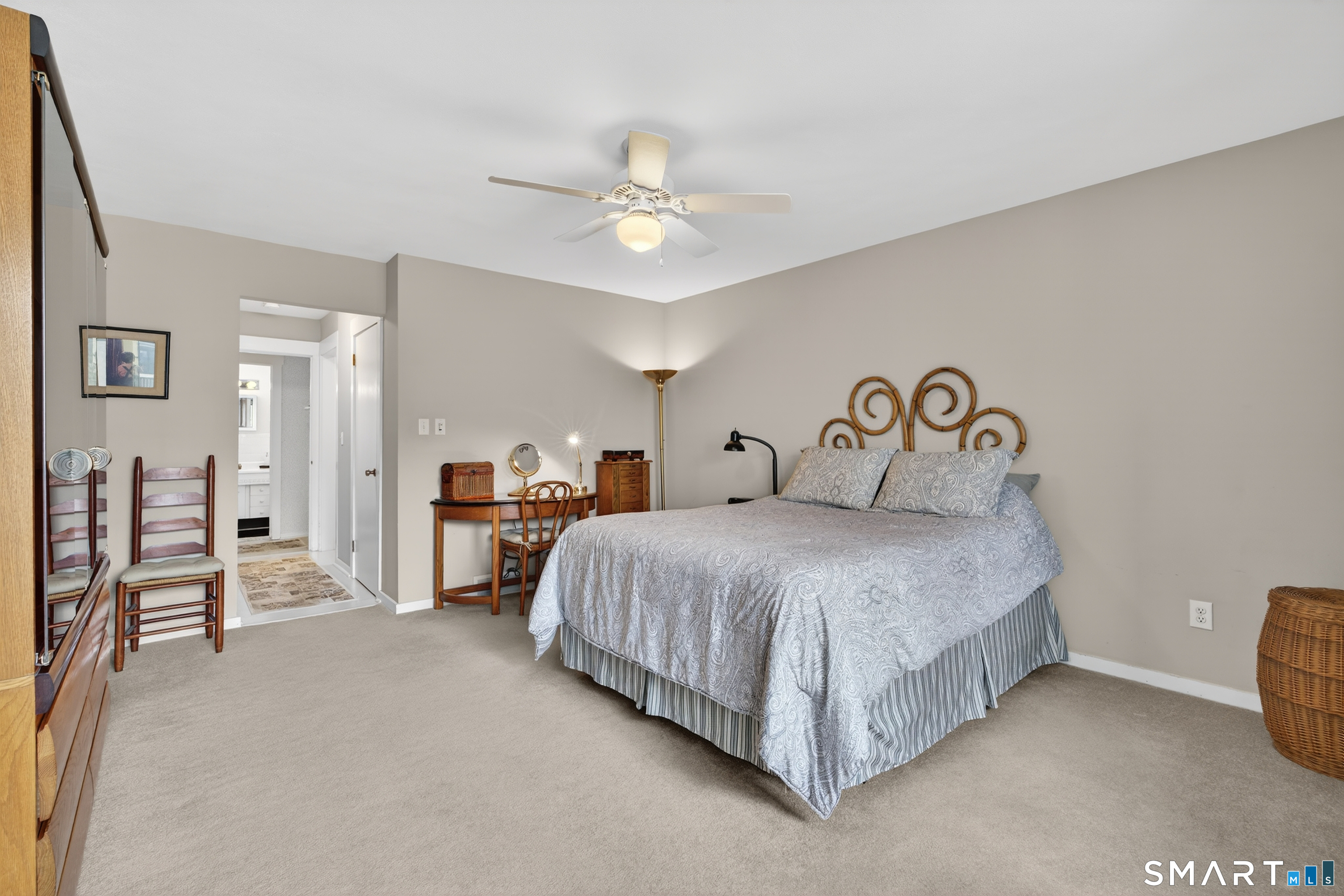 196 Apache Lane, Unit A Stratford, CT 06614 - Photo 22 of 40 a spacious bedroom with a bed and a chandelier