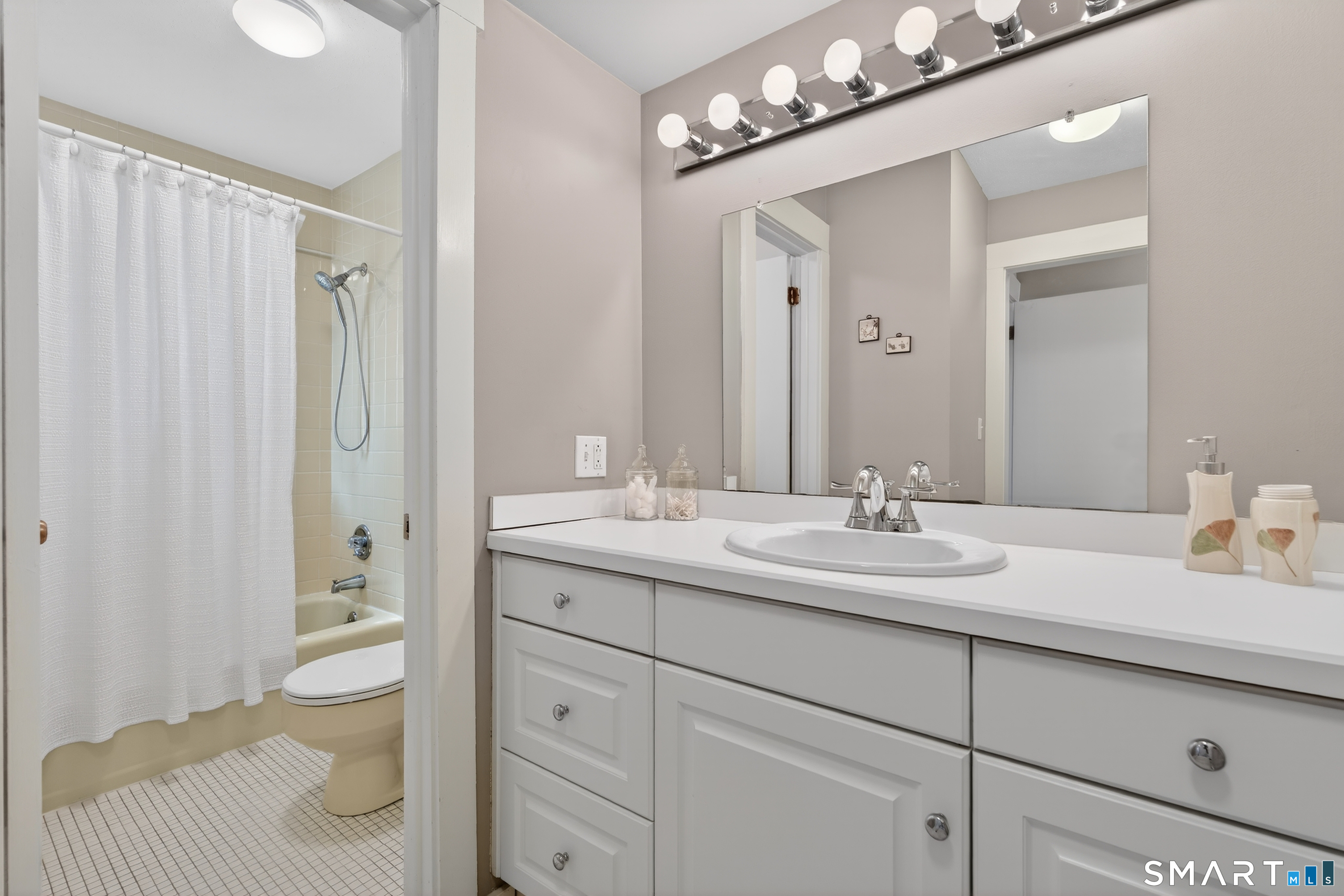 196 Apache Lane, Unit A Stratford, CT 06614 - Photo 25 of 40 a bathroom with a granite countertop sink a toilet and a mirror