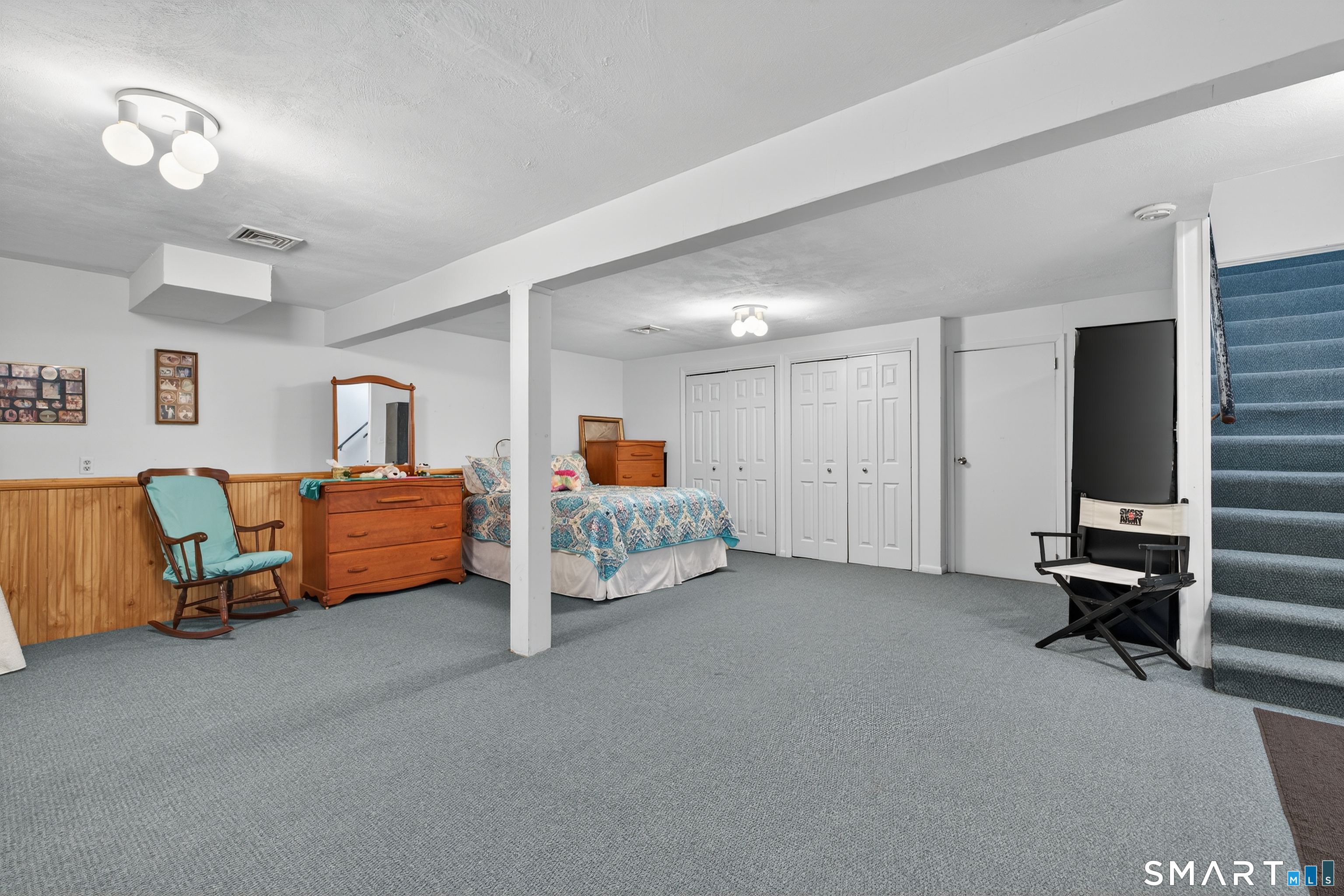 196 Apache Lane, Unit A Stratford, CT 06614 - Photo 27 of 40 a bed room with furniture and a flat screen tv