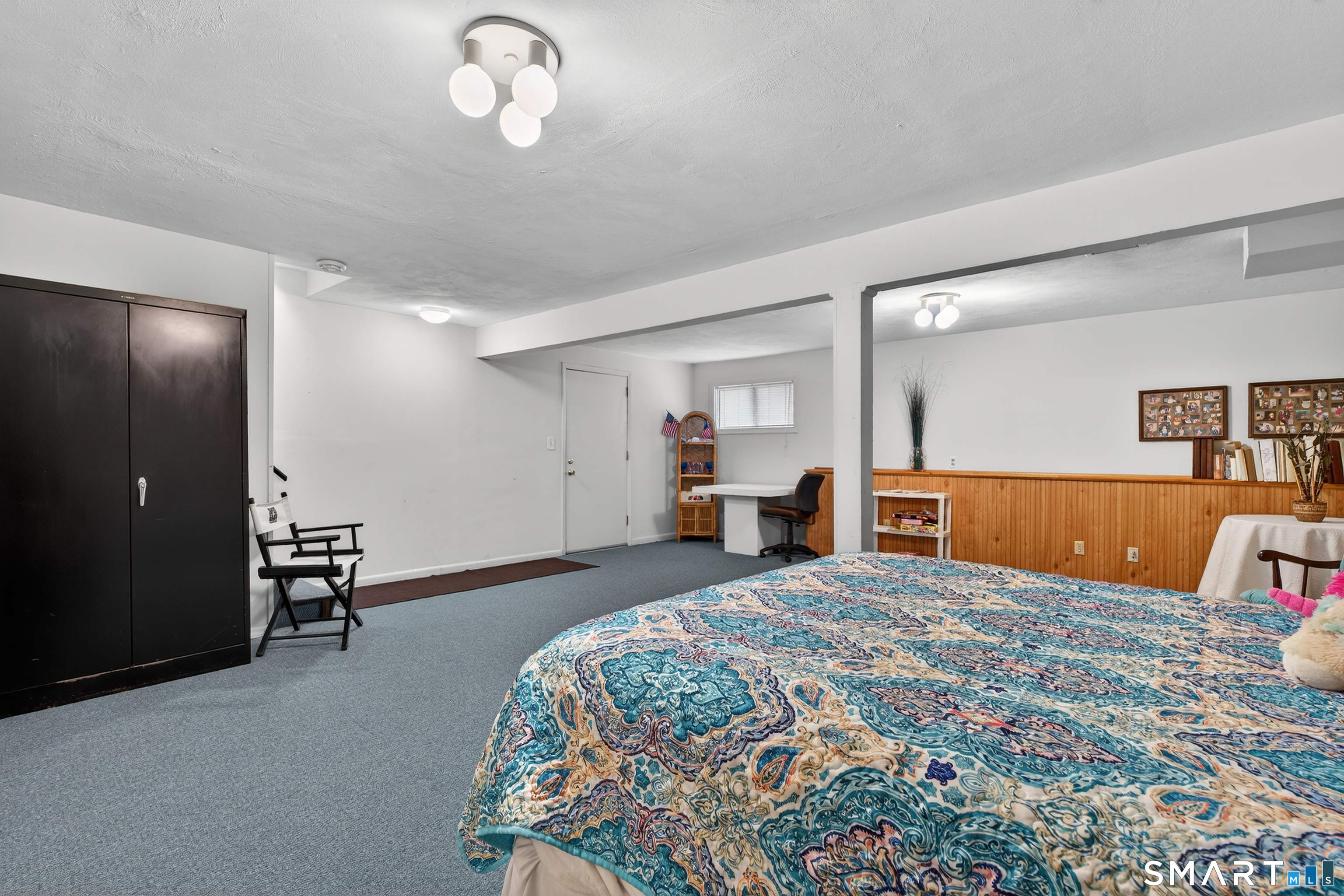 196 Apache Lane, Unit A Stratford, CT 06614 - Photo 31 of 40 a bedroom with a large bed and a chandelier