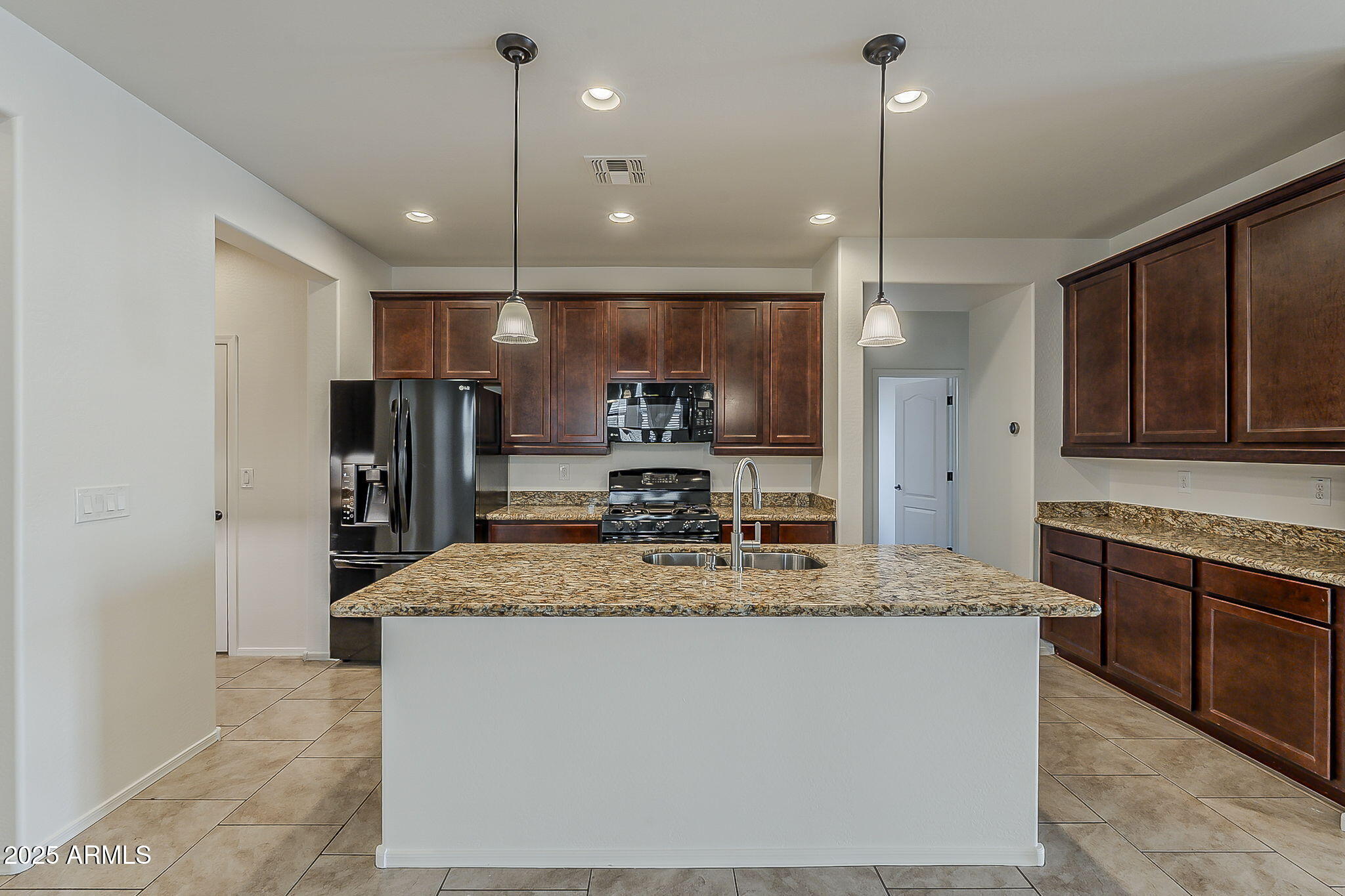 2008 East Stacey Road Gilbert, AZ 85298 - Photo 14 of 50 a kitchen with kitchen island granite countertop a sink a counter top space stainless steel appliances and cabinets