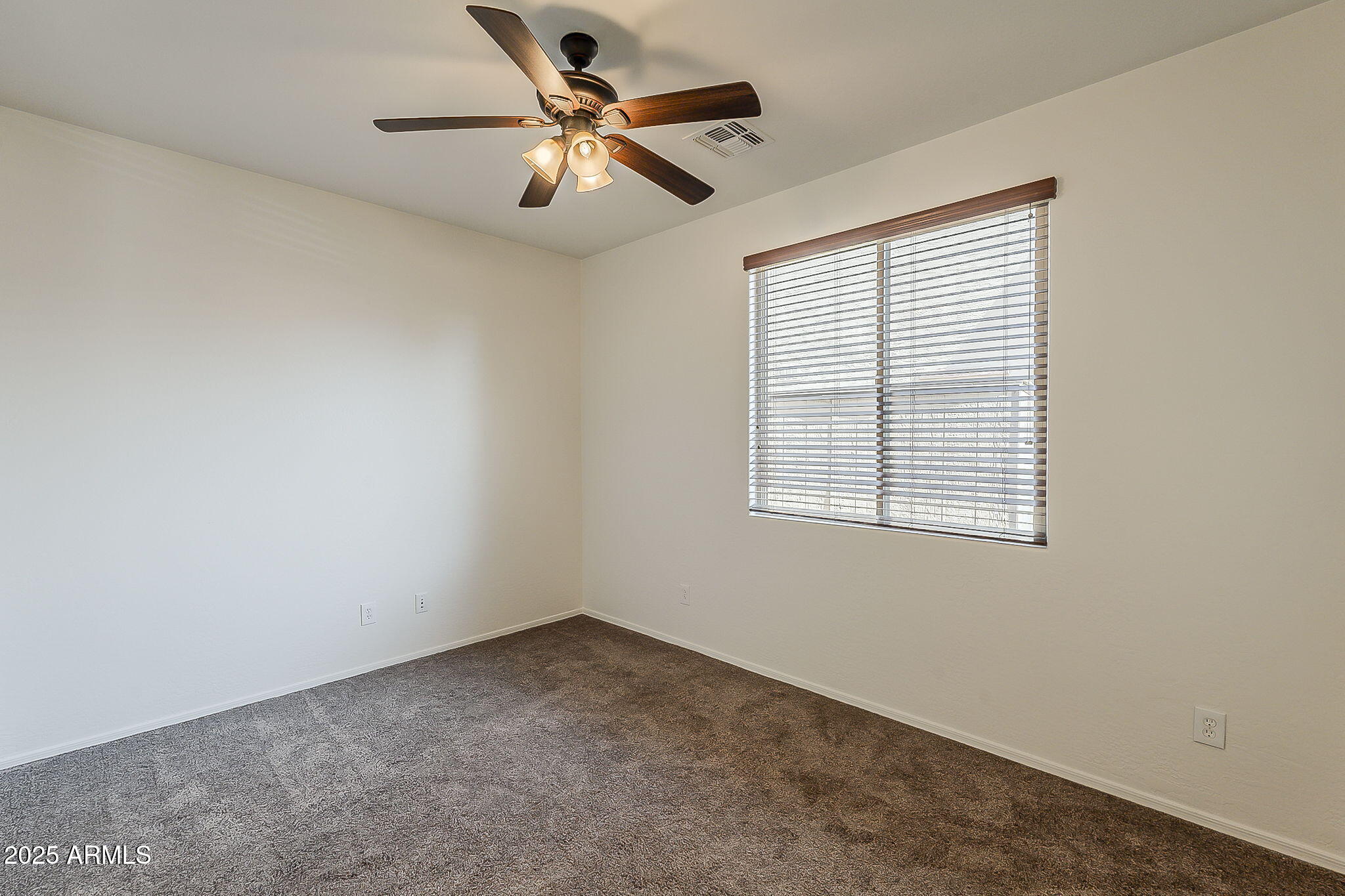 2008 East Stacey Road Gilbert, AZ 85298 - Photo 22 of 50 an empty room with a window and a fan