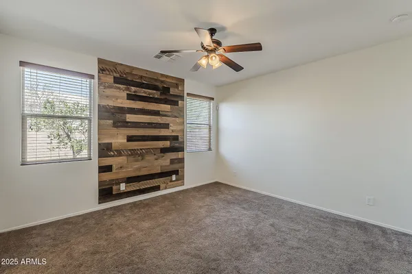 a view of a livingroom with a ceiling fan and window