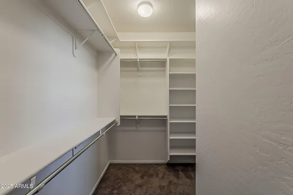 a bathroom with a granite countertop sink a mirror and a shower