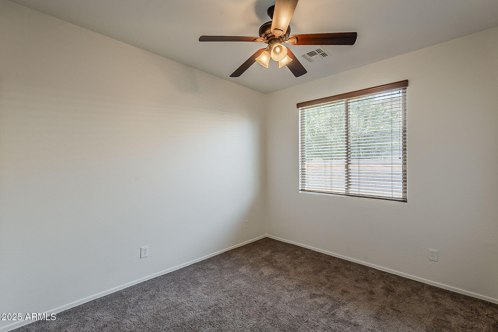 2008 East Stacey Road Gilbert, AZ 85298 - Photo 36 of 50 an empty room with a window and a fan