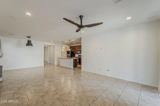 a view of a kitchen with a sink and a refrigerator