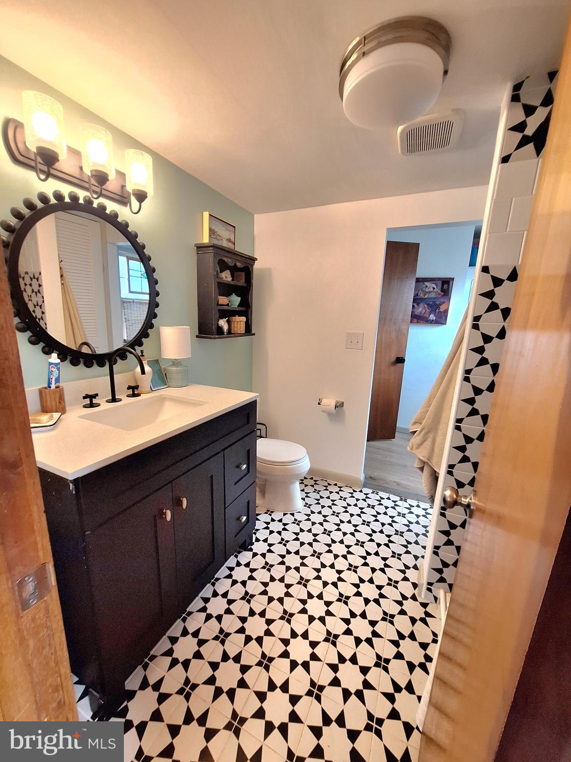9987 Capon River Road Yellow Spring, WV 26865 - Photo 25 of 42 a bathroom with a sink mirror vanity and a toilet