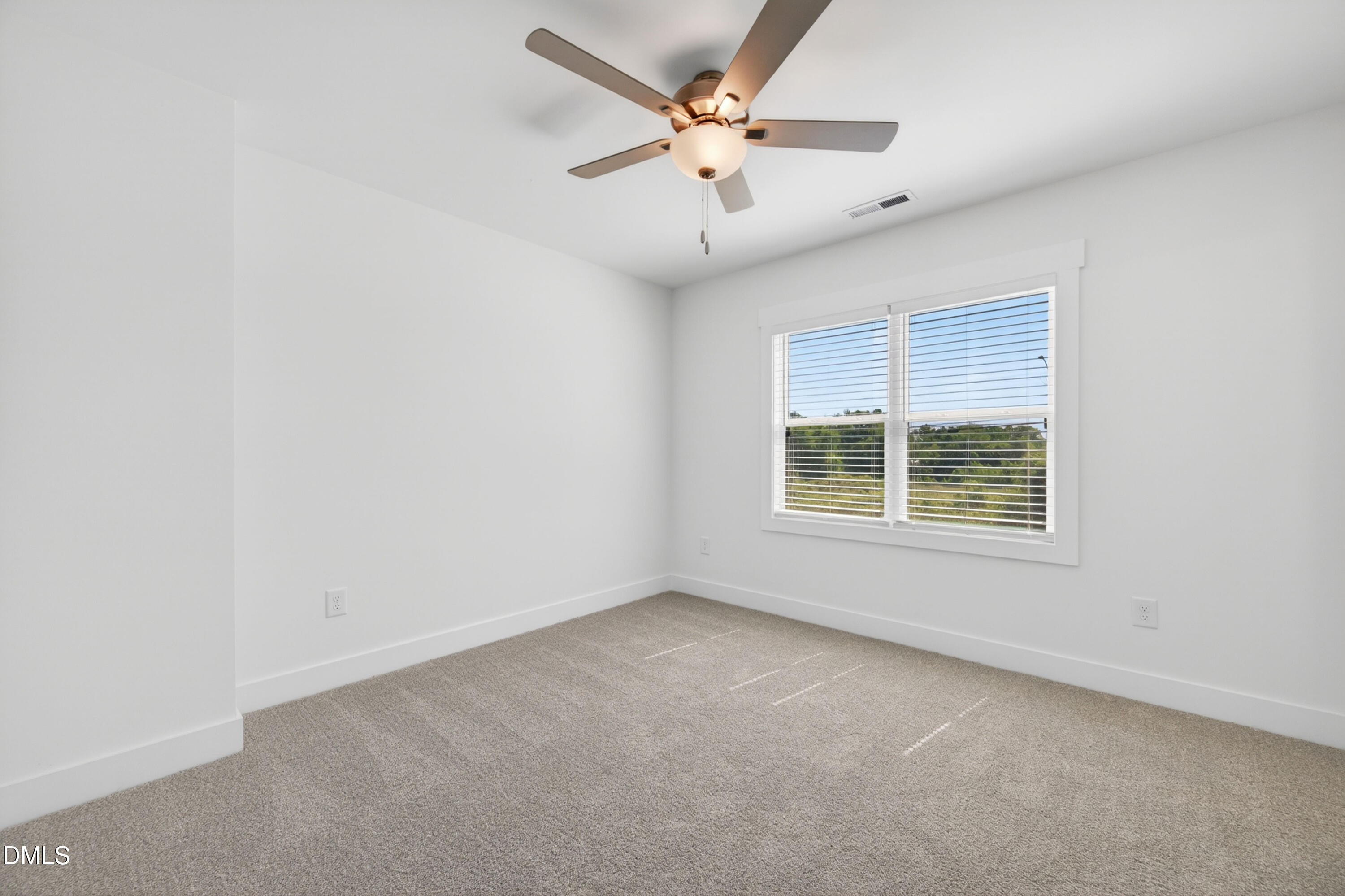 1256 Hurdle Mills Road Roxboro, NC 27573 - Photo 34 of 48 an empty room with a window and a ceiling fan