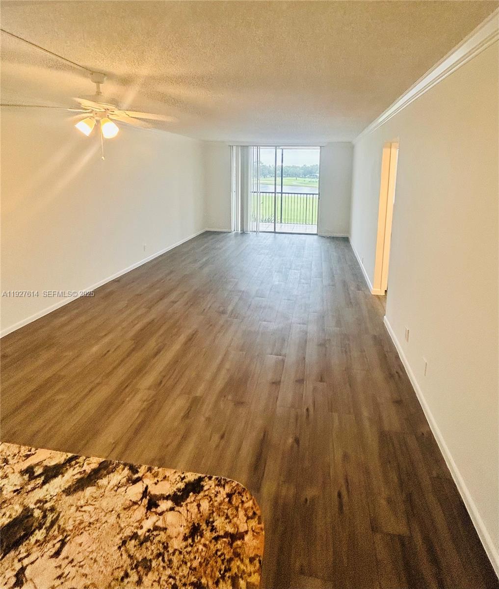 3100 West Rolling Hills Circle, Unit 310 Davie, FL 33328 - Photo 12 of 39 a view of an empty room with wooden floor and a window