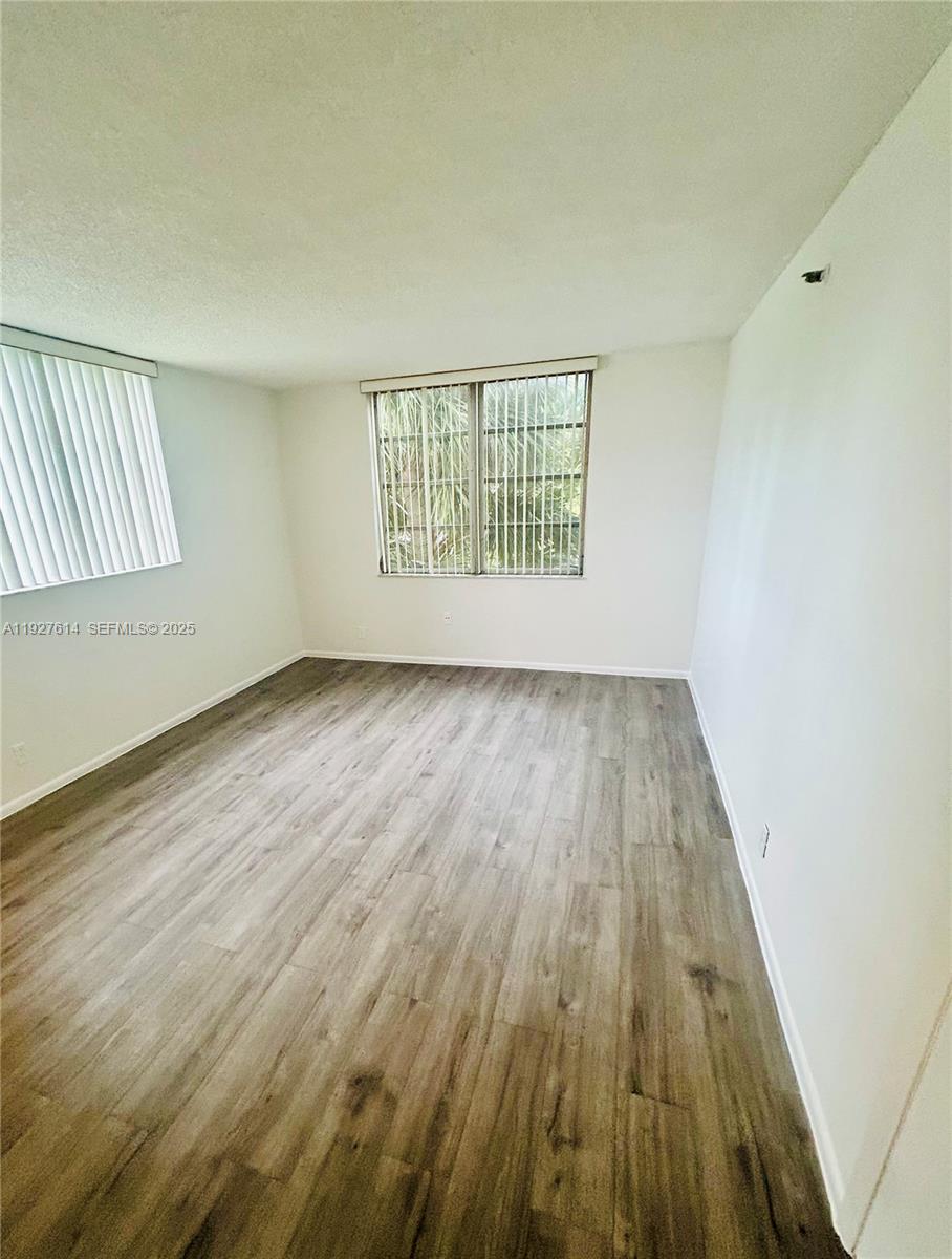 3100 West Rolling Hills Circle, Unit 310 Davie, FL 33328 - Photo 13 of 39 an empty room with wooden floor and windows