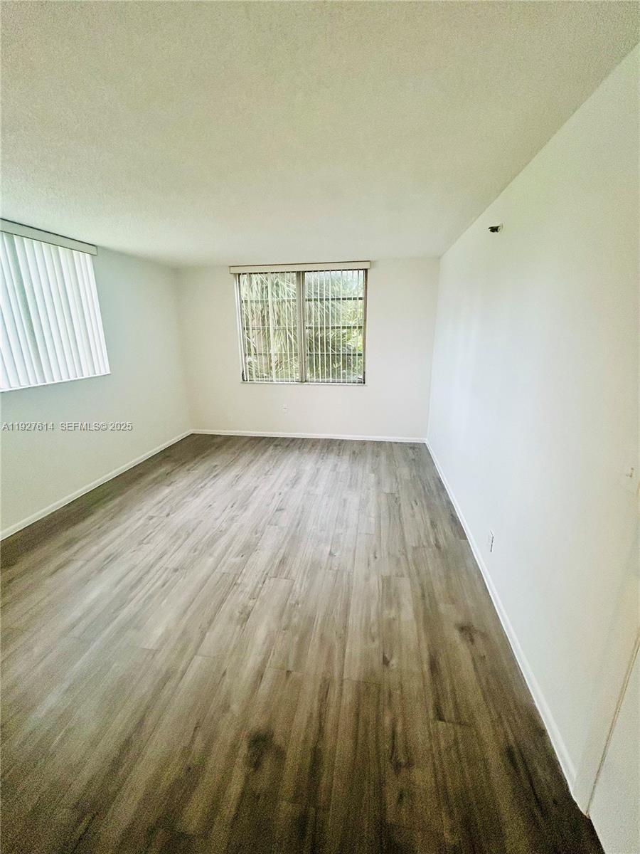 3100 West Rolling Hills Circle, Unit 310 Davie, FL 33328 - Photo 14 of 39 an empty room with wooden floor and windows